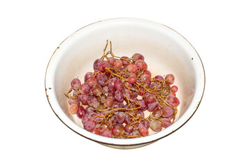 Grapes are pink in a plate on a white background.Pink Azalea grapes.Background of ripe grapes.
