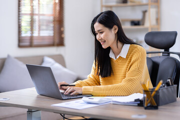 Image of young Business Asian woman work on laptop and calculator sitting at the desk indoors in home office, doing math finance tax, report, accounting, statistics, and analytical research concept.