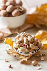Peanuts and walnuts on a light autumn background. Close up - 542997909