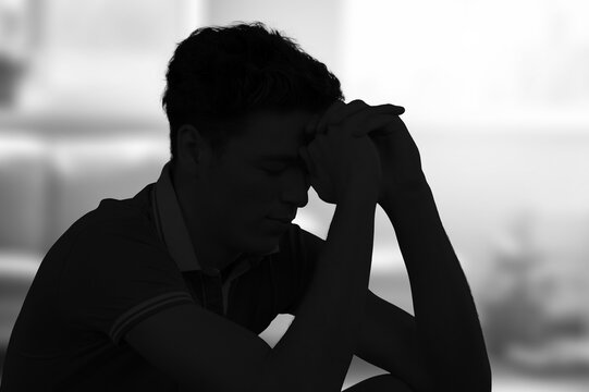 Silhouette of man in sad mood, crying alone