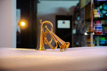 Closeup shot of two brass trumpets on a white cloth surface
