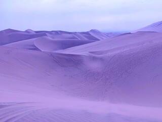 Purple sand dunes in the desert.