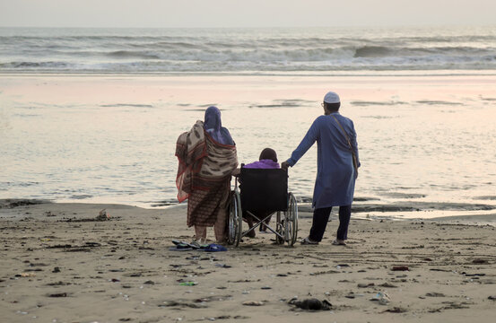 Disabled senior woman on beach with her son.this photo was taken from Cox's Bazar,Chittagong,Bangladesh.