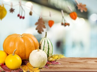 Naklejka na ściany i meble Fresh ripe decorative pumpkins on the desk