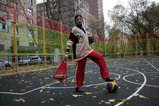 fashion style woman on the basketball sport playground with ball