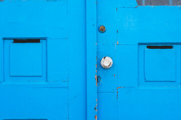 Blue metallic door with white doorknob as entrance to a home