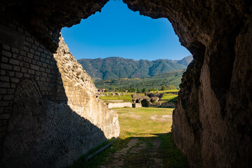 Roman amphitheater in the village of Avella, Italy. A beautiful sunny day with fairy-tale clouds in...