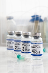 COVID-19 vaccine vials for vaccination labeled 1st, 2nd, 3rd and 4th doses for booster shot for...