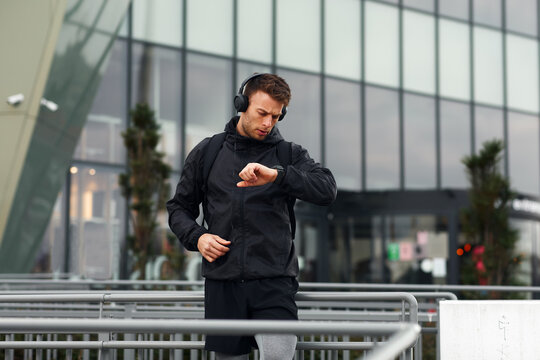 Attractive man listening to music via smartphone in the city