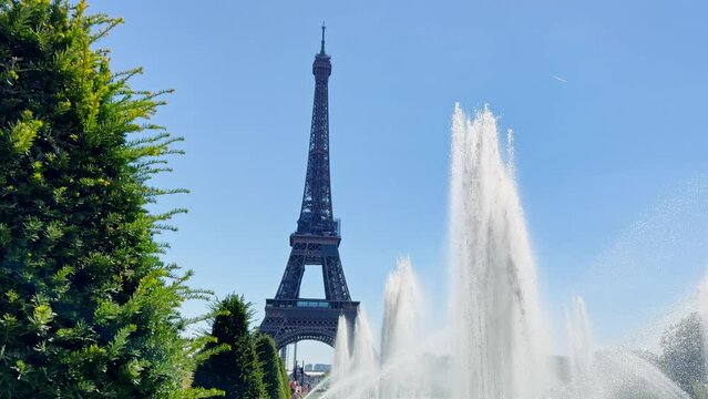 Fountain on sunny day over Eiffel tower from Trocadero in Paris