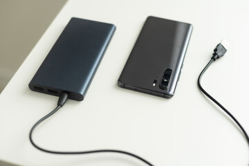 Power bank for charging mobile devices. Smartphone charger. External battery for mobile devices.