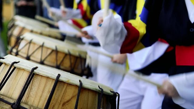 Group of musicians play drums outdoors