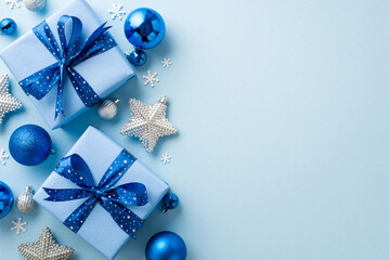 New Year concept. Top view photo of big gift boxes with ribbon bows blue and silver baubles sparkle...
