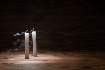 two extinct candles on wooden background in minimalist room interior with copy space, concept