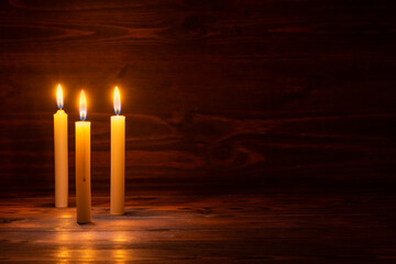 burning candles on wooden background, room interior copy space