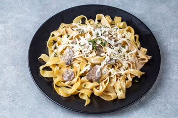 Homemade Italian fettuccine pasta (Fettuccine al Funghi Porcini) with mushroom and cream sauce. Traditional Italian cuisine.