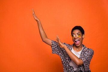 Photo of excited carefree person have fun enjoy dancing clubbing isolated on orange color background