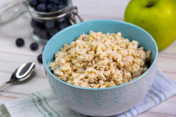 Healthy breakfast oatmeal porridge in bowl. Hot mashed oats, vegan vegetarian weight loss diet breakfast food - obrazy, fototapety, plakaty