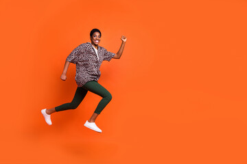 Fototapeta na wymiar Full length body size view of attractive cheerful trendy girl jumping running motion copy space isolated on bright orange color background