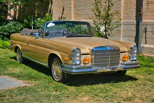 BADEN BADEN, GERMANY - JULY 2022: sand yellow beige Mercedes-Benz W111 280SE Coupe cabrio roadster, oldtimer meeting in Kurpark
