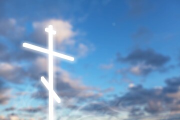 Christian light cross in the blue sky with clouds