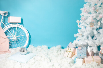 Christmas shooting location with white christmas tree decorated with toys, present boxes, snow and...