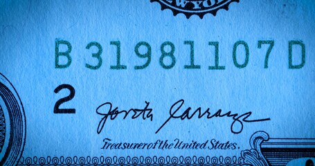 Front side of a one dollar bill bearing the signature of the treasurer united states and the bill number. A paper bill of the American currency with face value of 1 dollar. Macro shot of dollar.