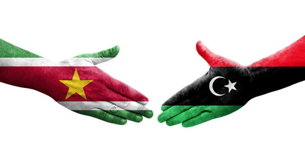 Handshake between Libya and Suriname flags painted on hands, isolated transparent image.