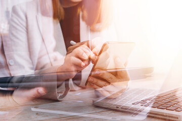 businesswoman hand working with laptop computer, tablet and smart phone in modern office with virtual icon diagram at modernoffice in morning light