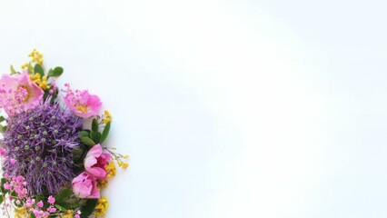 Bouquet in lilac-pink tones. Decorative bow and roses on a white background. Delicate floral arrangement. Background for a greeting card.