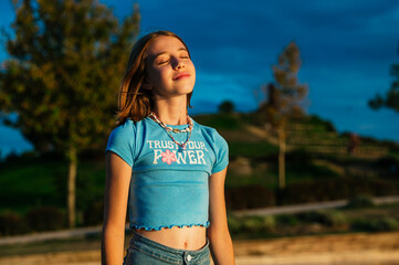 The little girl very happy relaxed in nature.