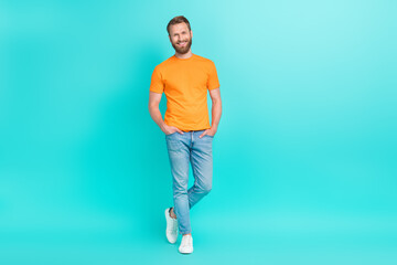 Full size photo of good mood handsome man with masculine beard dressed orange t-shirt arms in...