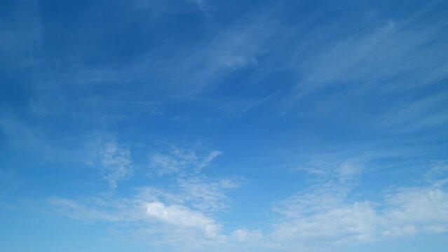 Tropical summer sunlight. Blue sky with cirrus clouds. Fluffy layered cirrus clouds sky atmosphere. Timelapse.