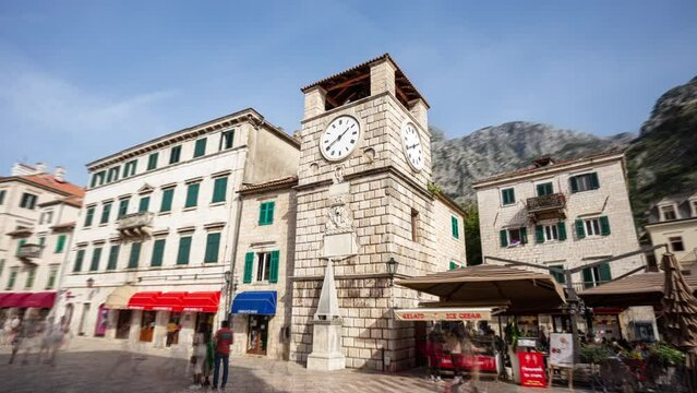 Kotor Montenegro hyper-lapse: time-lapse of stone clock tower, on  the Square of Arms (Trg od oruzja), in old historical town and tourist destination.