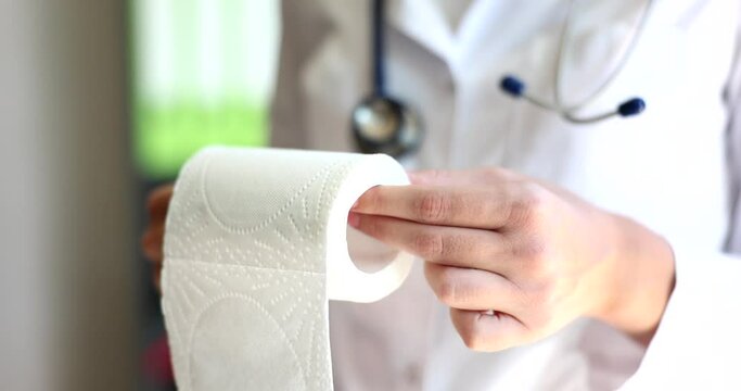 Doctor demonstrates roll of toilet paper and problems with diarrhea
