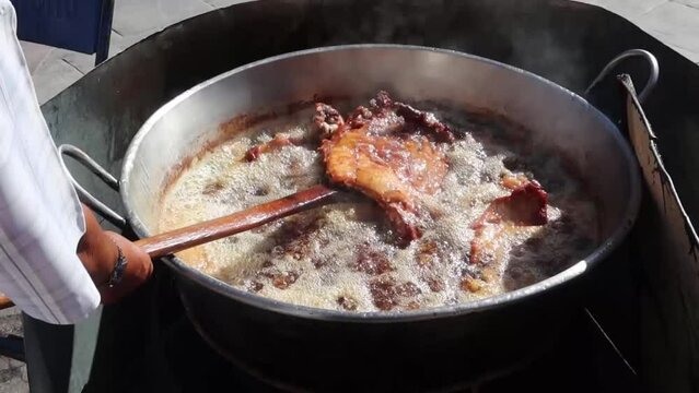 Saucepan with pork carnitas frying in lard in Mexico