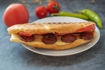 Turkish traditional toast sandwich, cheddar cheese, tomato, sausage (Turkish name; Ayvalık toast)