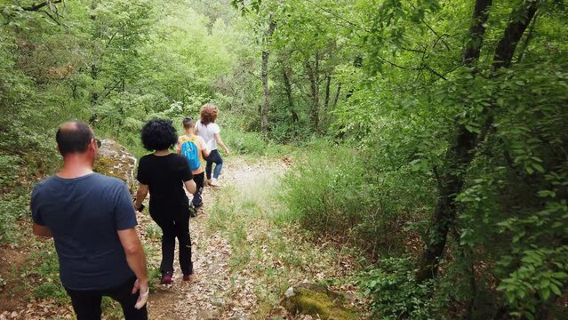 Slow motion of multi generation family having fun and adventure in the green mountain forest in summer. Family, hike concept