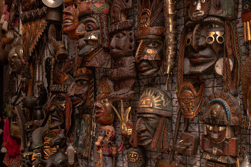 Masks, statues, souvenirs and souvenirs from Peru related to the Inka culture. Ancestral decoration of gods, brown colors. - obrazy, fototapety, plakaty