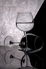 Still life with glass goblets on a gray background