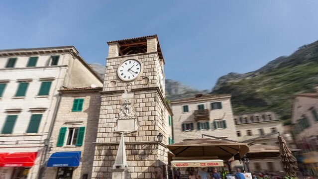 Kotor Montenegro hyper-lapse: time-lapse of stone clock tower, on  the Square of Arms (Trg od oruzja), in old historical town and tourist destination.