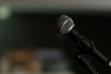 Approach to a microphone mounted on a tripod, in a bar to sing or speak