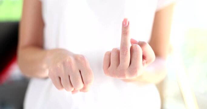 Female hand flips the middle finger up