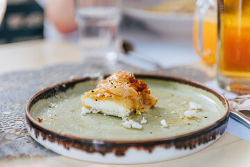 Authentic Greek Fried Cheese, Saganaki or Feta, tasty appetizer, crunchy on the outside with honey and sesame seeds
