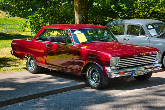 BADEN BADEN, GERMANY - JULY 2022: red 1965 Chevrolet Chevy II Nova SS coupe, oldtimer meeting in Kurpark