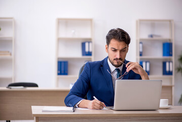Young male employee working in the office