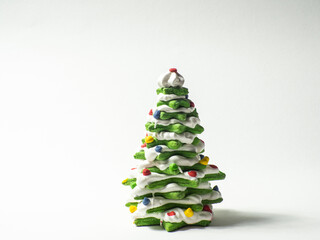 Green cookie christmas tree made by star cookie cutter on white background. New Year Christmas card. Matcha Green Tea Gingerbread Christmas tree Cookies covered with white chocolate. Copy space.