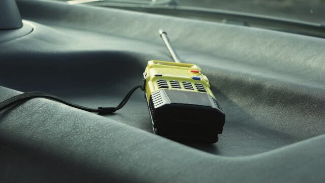 An yellow vintage walkie-talkie lays in car