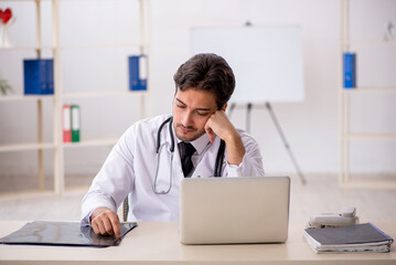 Young male doctor working in the clinic