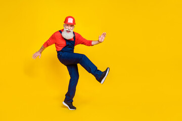 Full size photo of handsome grandparent craftsman dancing have fun cheerful dressed safety uniform...
